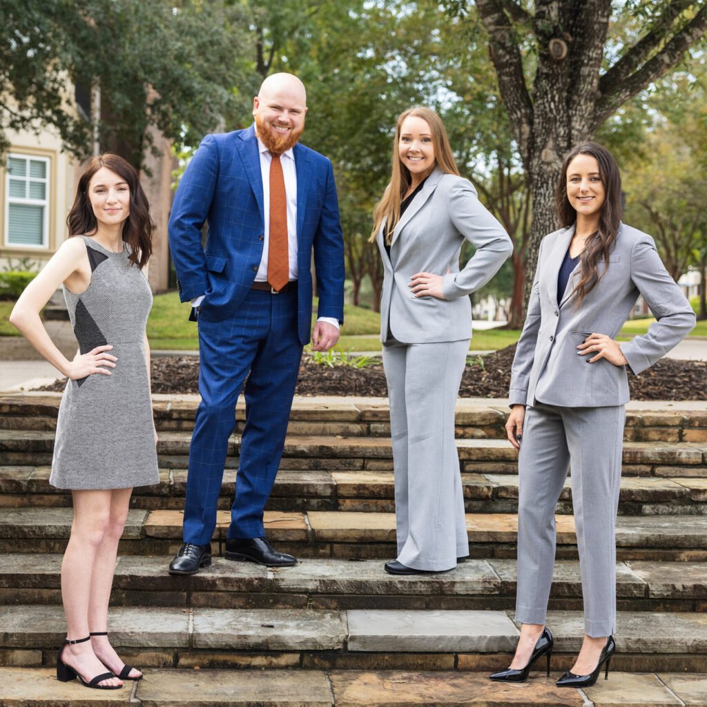 Four business professionals on stairs at an outdoor location